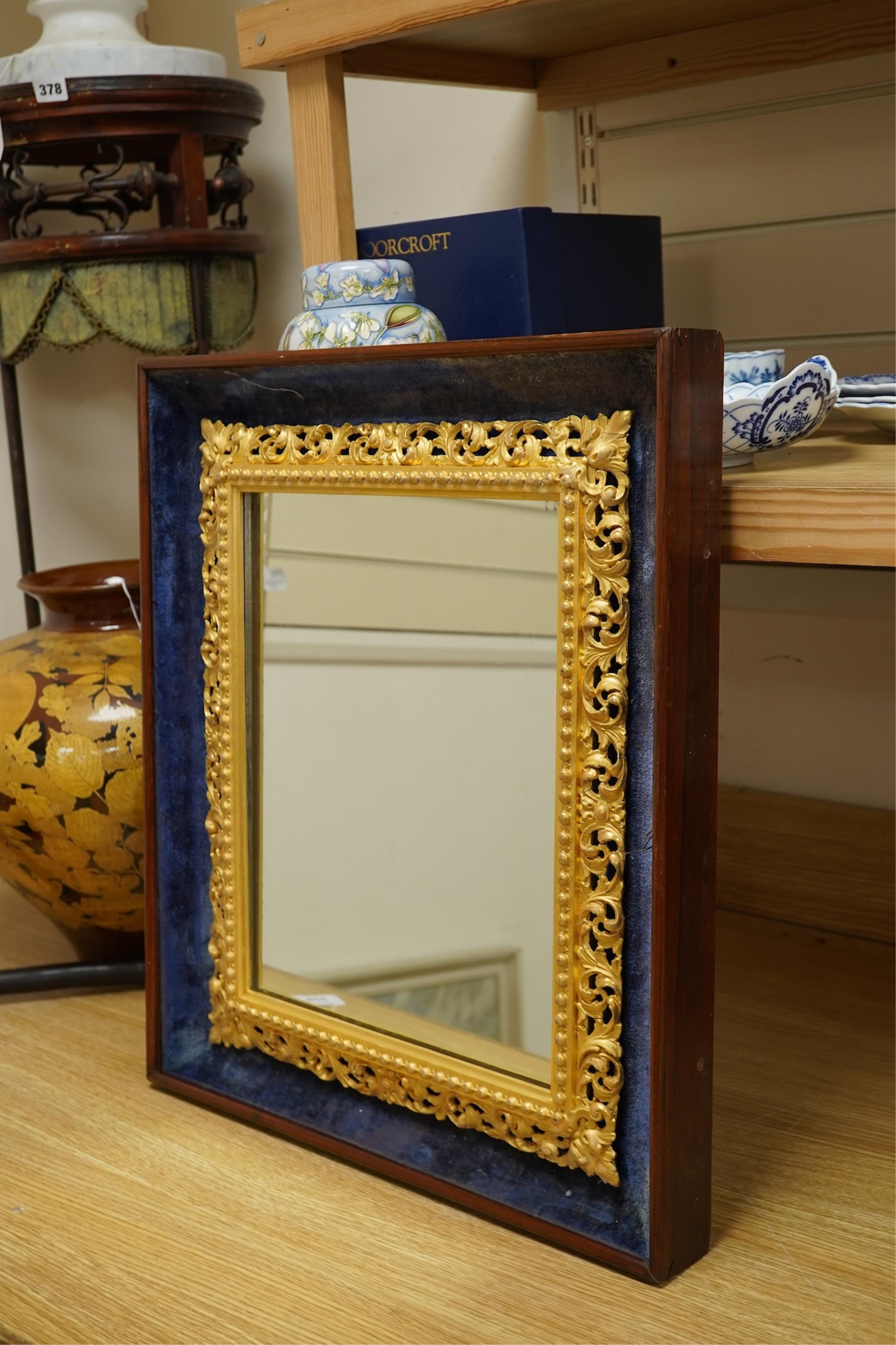 A 19th century carved gilt wood framed mirror, displayed within a blue velvet mount and outer rosewood frame, 48cm wide x 56cm high